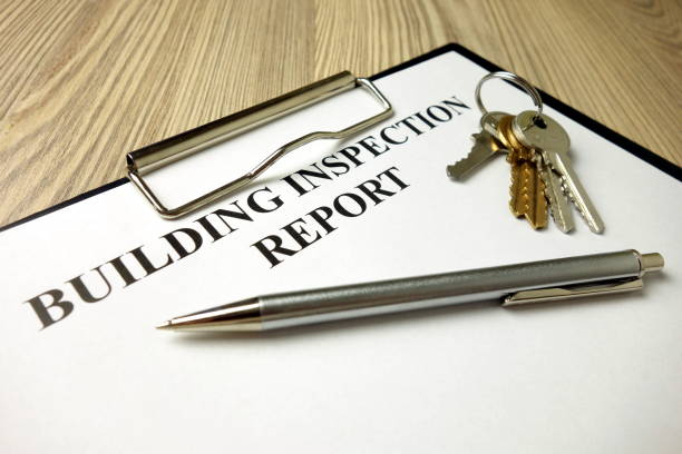 Building inspection report with pen and keys, real estate concept